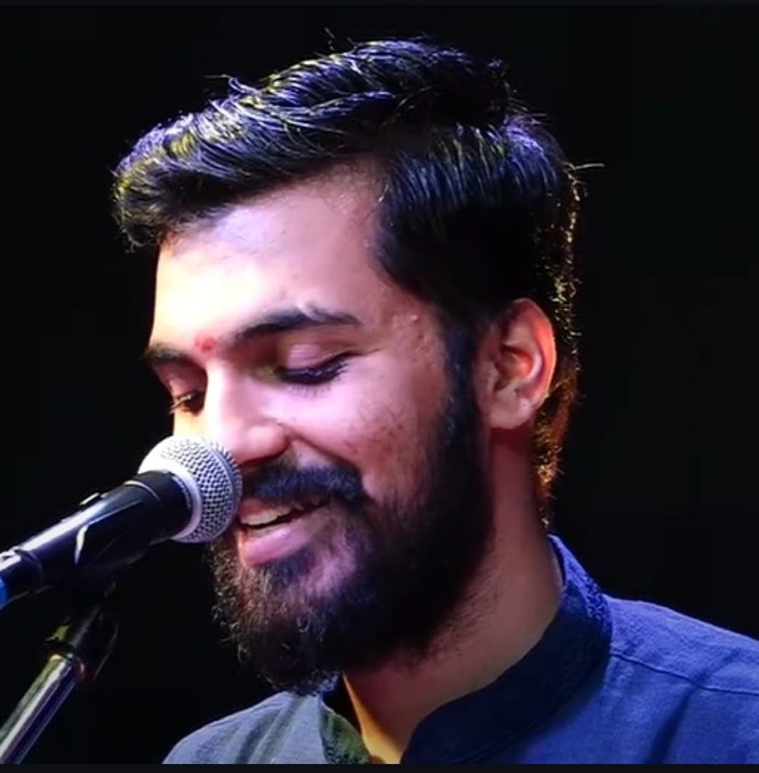 A singer with eyes closed at the microphone